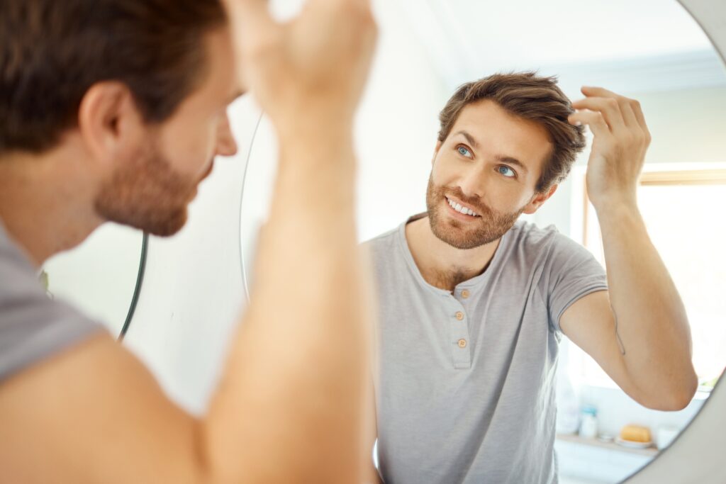 Bathroom Mirror Reflection And Happy Man With Full Head Of Hair